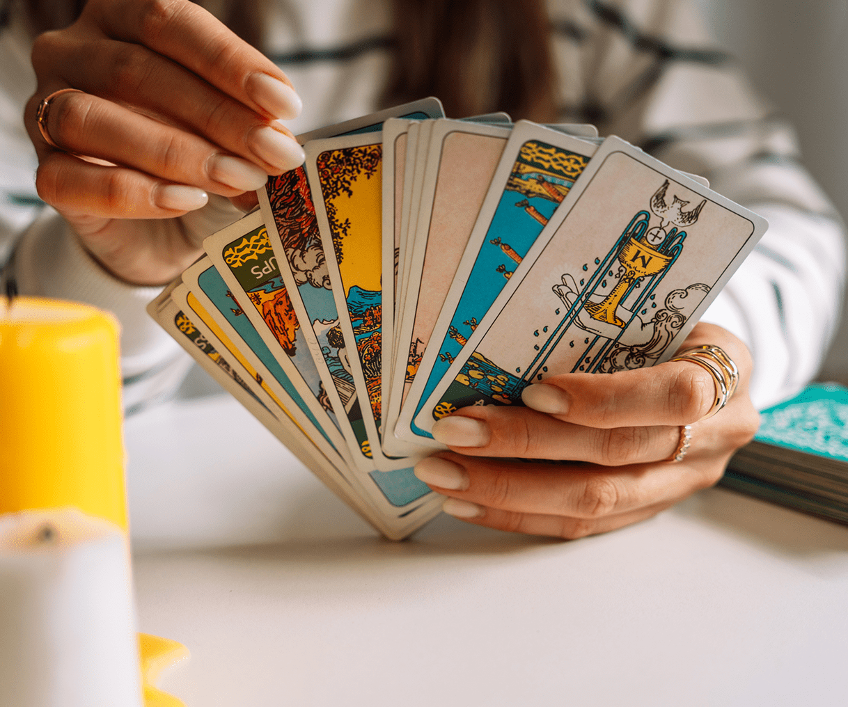 Tarot reading with yellow candle nearby
