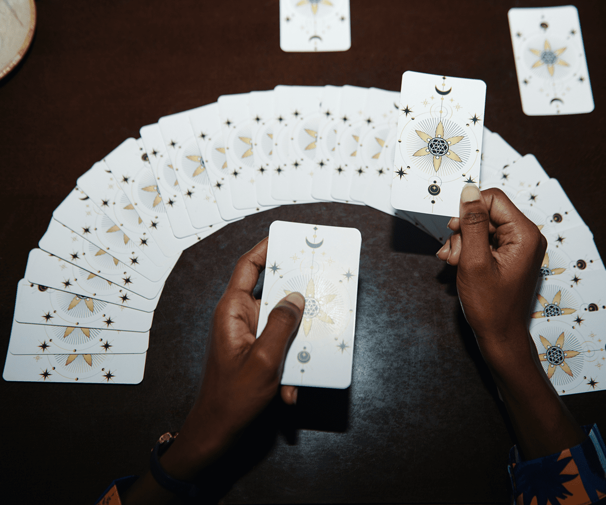 Person holding tarot cards